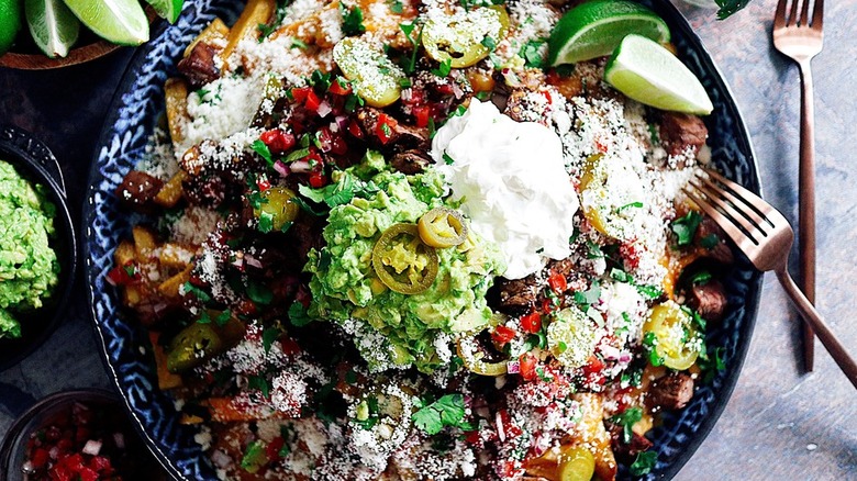 Beef, guacamole, and veggies over fries