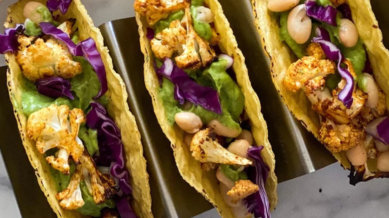 Three hard tacos with cauliflower and lettuce