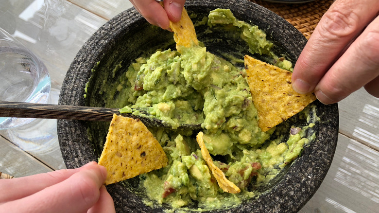 Gray bowl of guacamole and chips