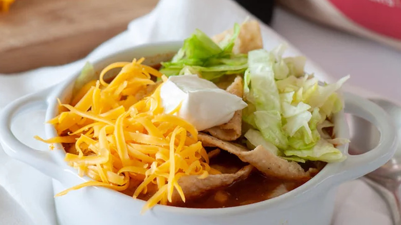 crock of taco soup and toppings.