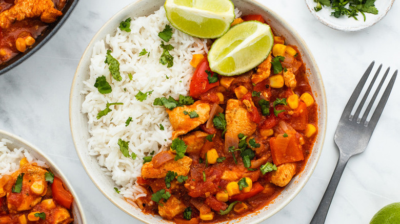 Bowl of red chicken stew and rice