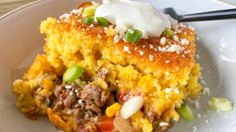 Cornbread, veggies and meat in a dish