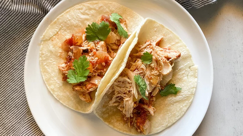 Flour tortillas with cooked chicken and tomatoes