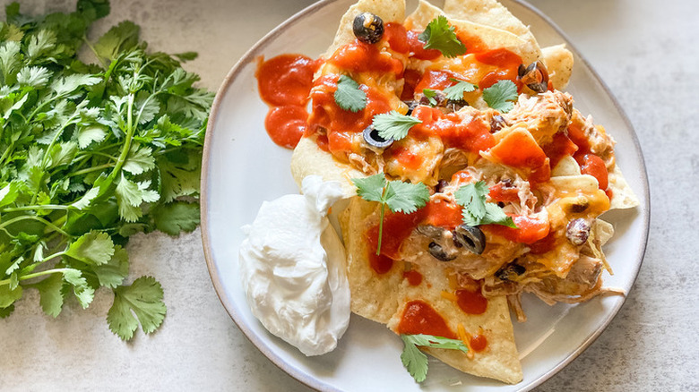 Plate of chicken nachos with red sauce