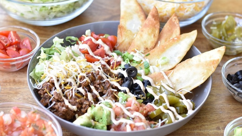 Bowl with beef, lettuce, cheese, tomatoes, and olives