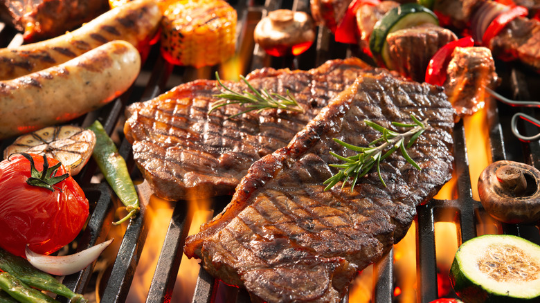 Meat and vegetables cooking over an open fire