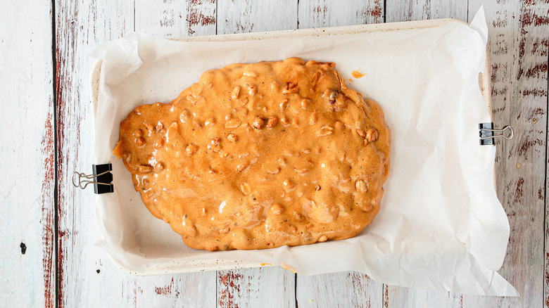 peanut brittle batter in baking sheet