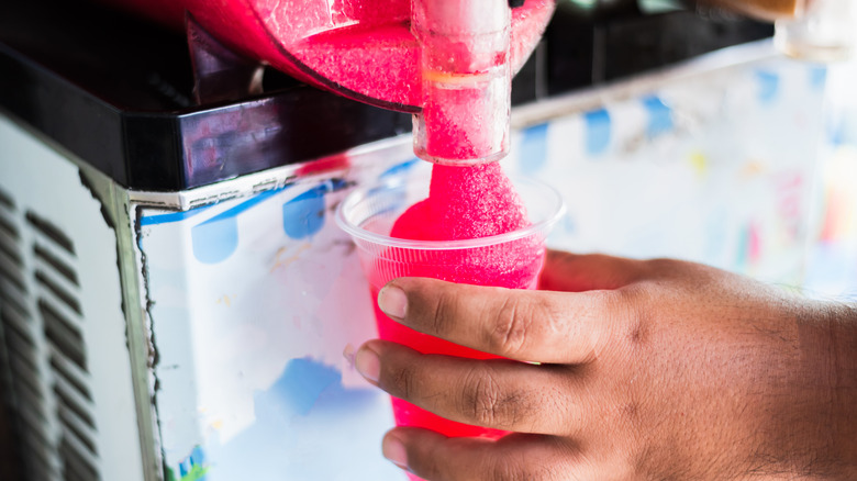 A slushy machine dispensing a drink