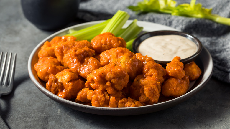 Wings and ranch dressing on a white plate