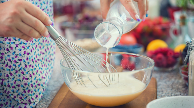 Person whisking milk