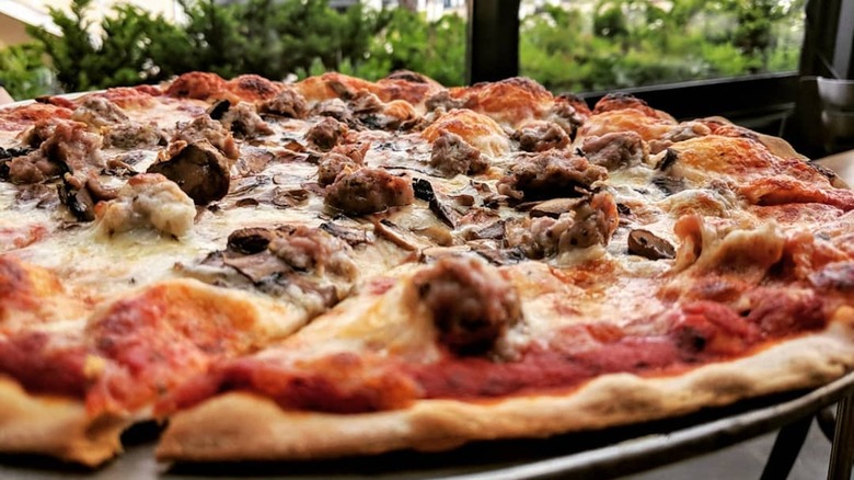 Pizza with sausage, mushrooms, onions