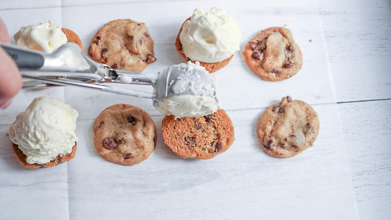 scooping ice cream onto cookies