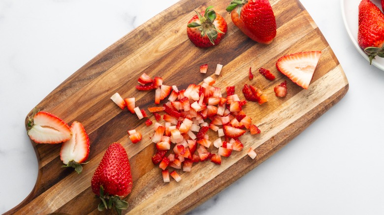 Chopped strawberries on a cutting board