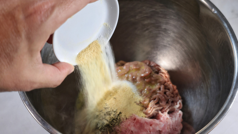 pouring spices into mixing bowl