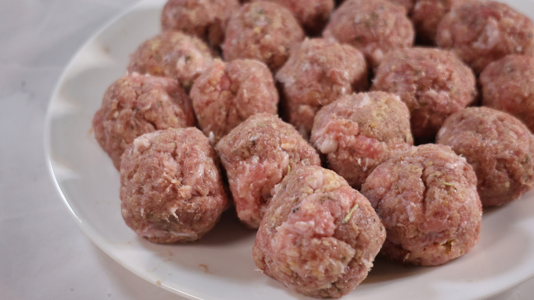 plate of uncooked meatballs