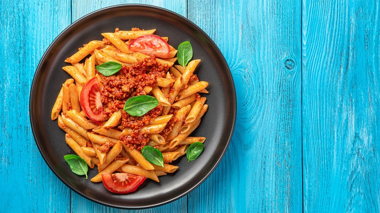 plate of pasta on blue table