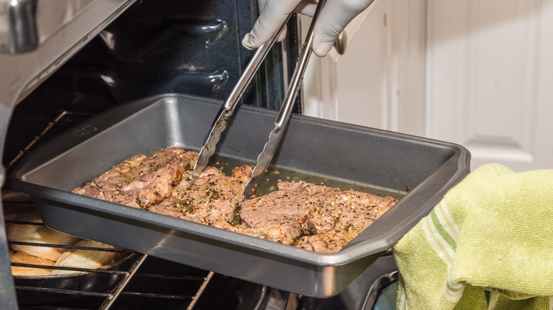 Hands reverse-searing steak