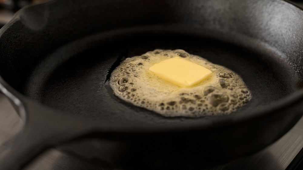 Butter melting in cast iron pan