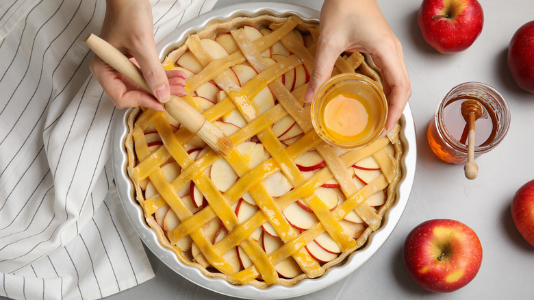 Brushing pie with egg wash 