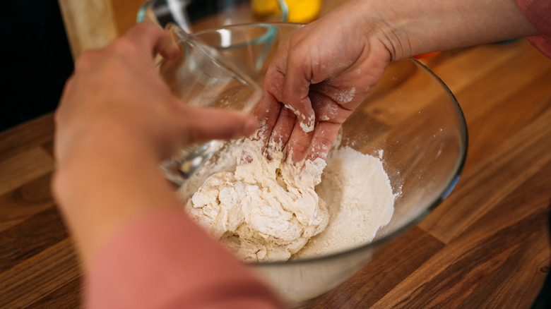 Woman pouring water into bowl