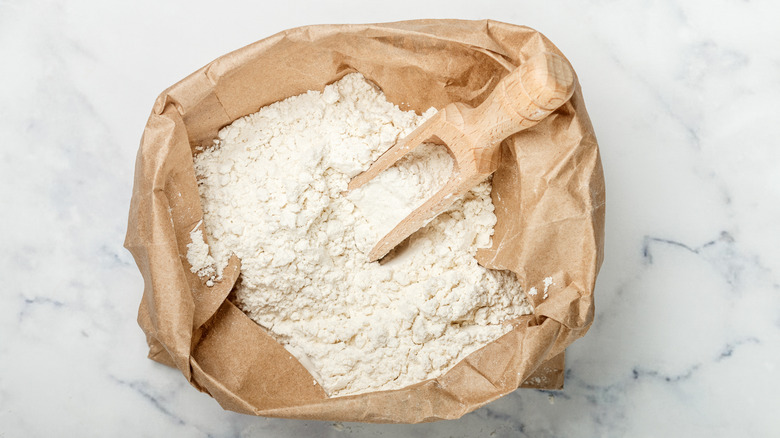 sack of flour with wooden scoop