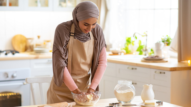 woman mixing dough by hand