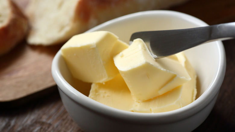 Butter in cup with knife
