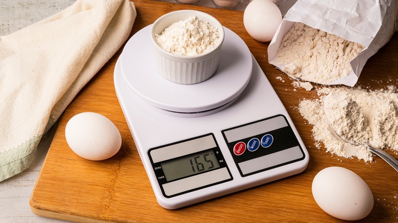 weighing flour on kitchen scale