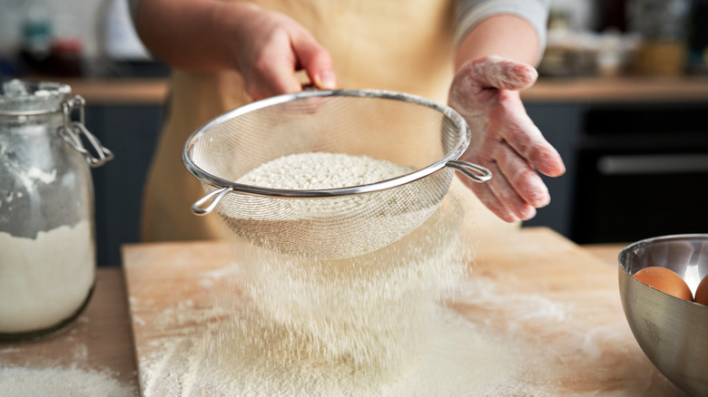 sifting flour onto baking board