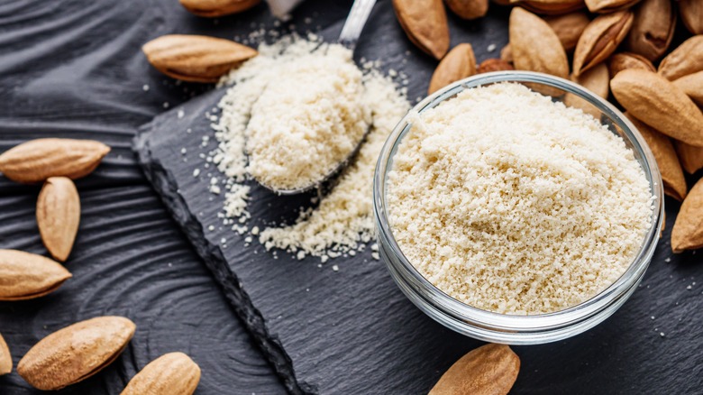 bowl of almond flour and scattered almonds