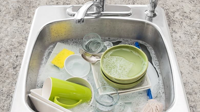 Dishes soaking in soapy water