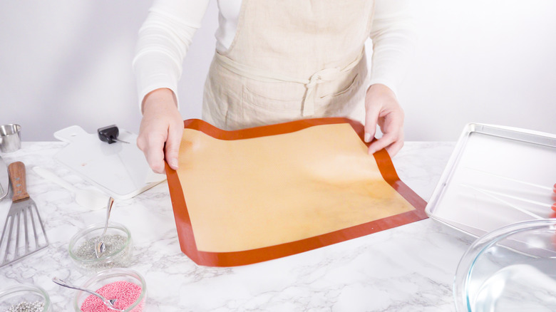 Woman holding floppy silicone mat