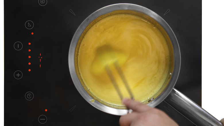 person whisking custard