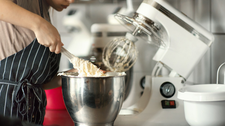 person using stand mixer