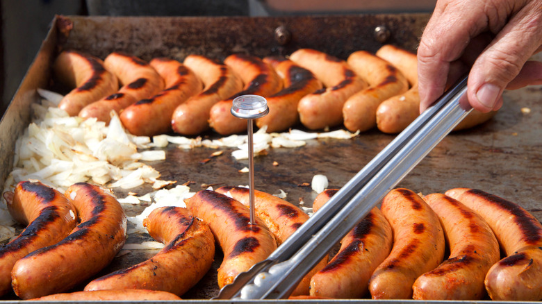 Sausages cooking with thermometer