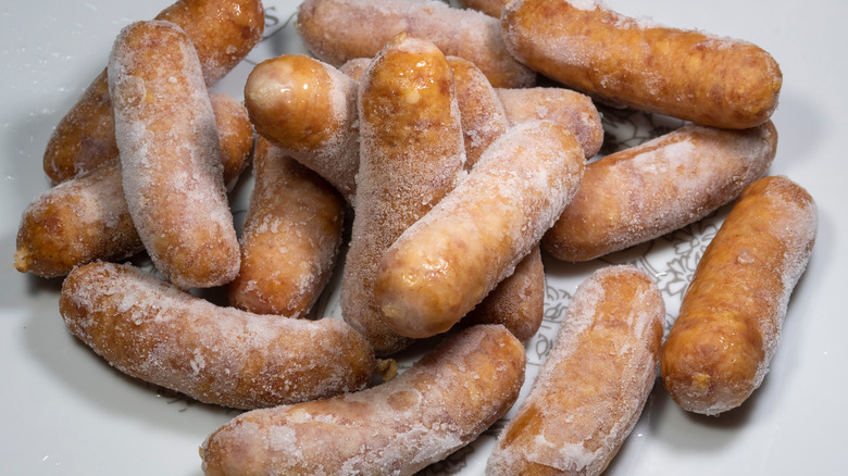 Frozen sausages on plate