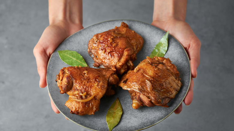 Crispy chicken thighs on plate