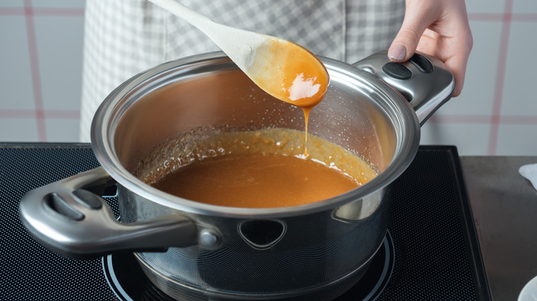 Woman stirring pot with spoon