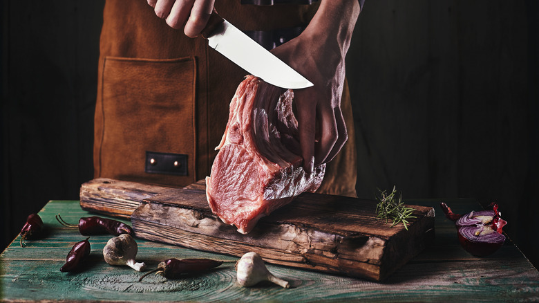 Man slicing raw meat