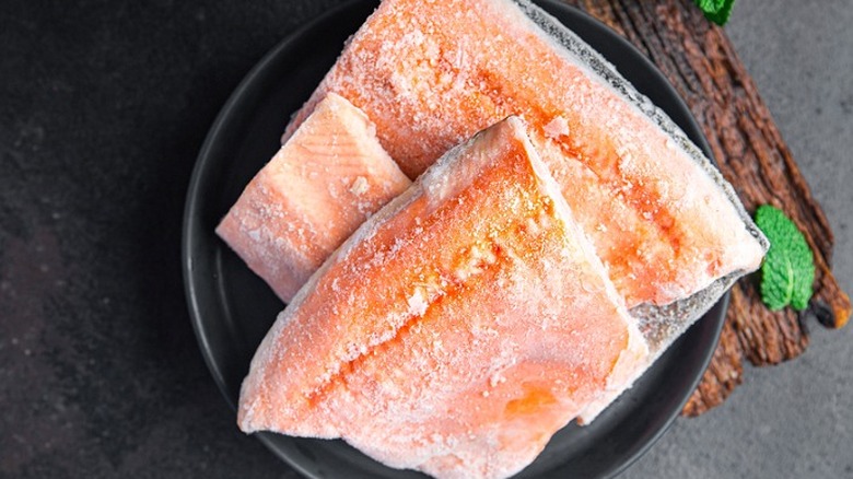 frozen fish filets on black plate