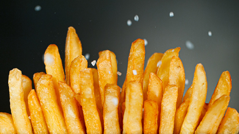 Salt being added to french fries