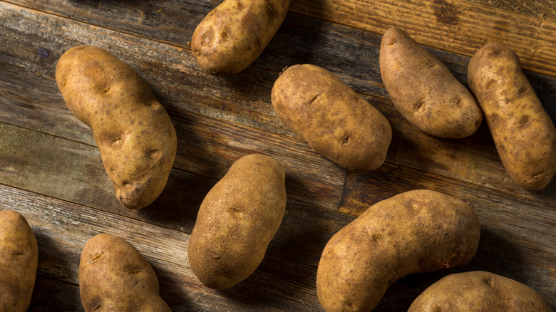 Russet potatoes against a wooden background