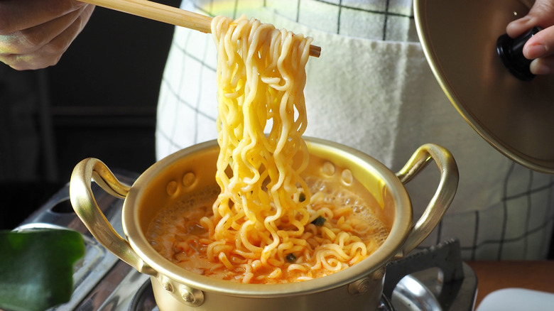 Chopsticks grabbing noodles