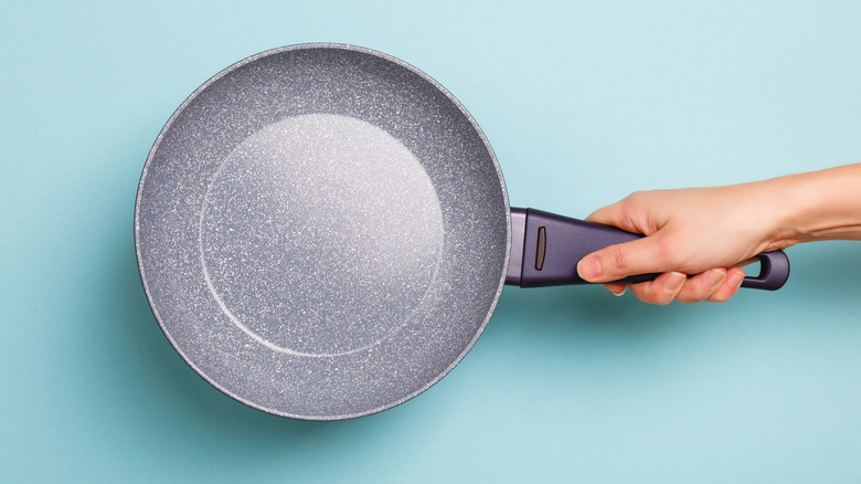 woman holding frying pan