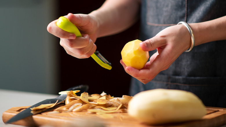 person preparing potatoes