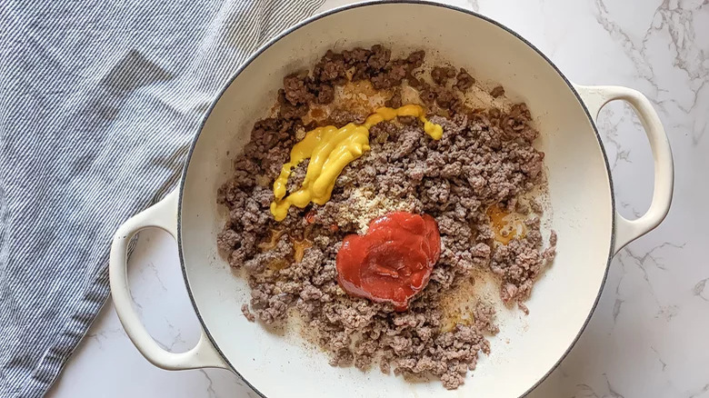 Meat in skillet mustard and ketchup