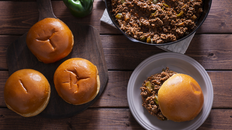 Ground beef in pan with sloppy joe buns