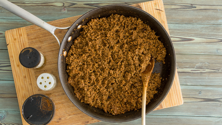 Ground beef in pan with seasoning