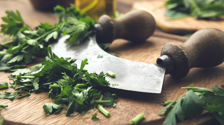 Mezzaluna chopping herbs