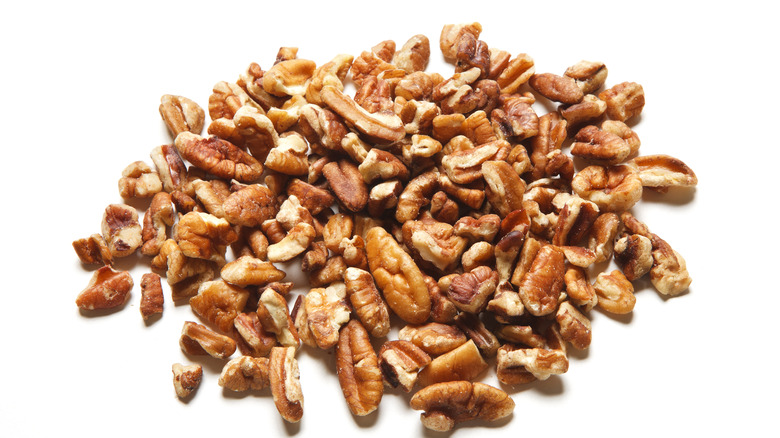 Chopped pecans on white background